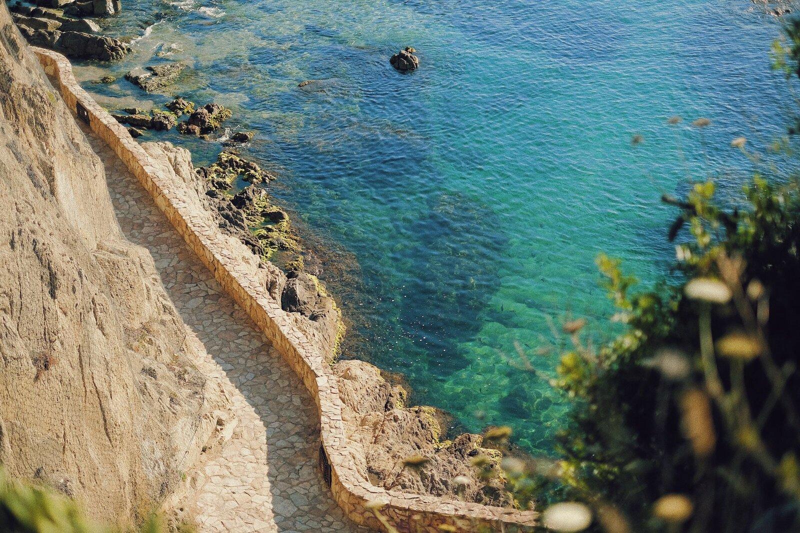 Rocky coastal path steps Mediterranean