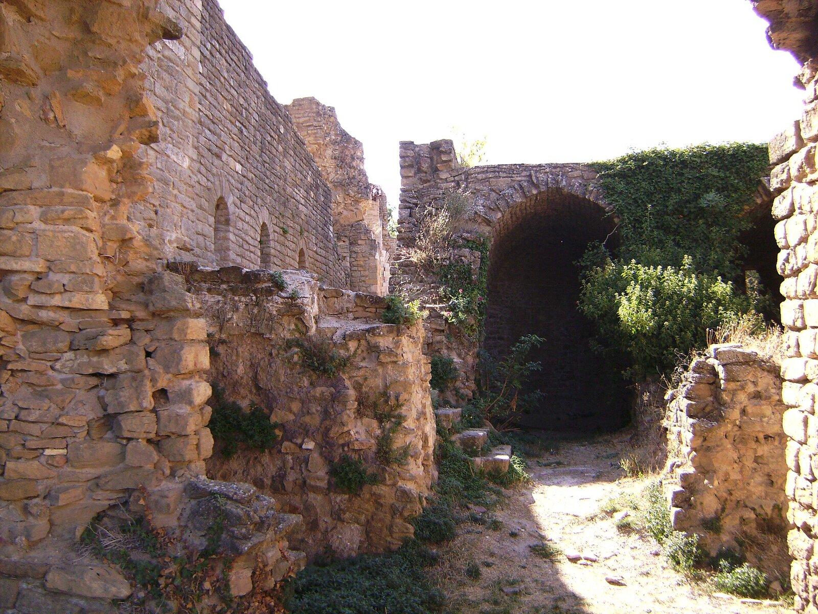 Stone walls and an arched passage in the Sant Pere ruins at Àger