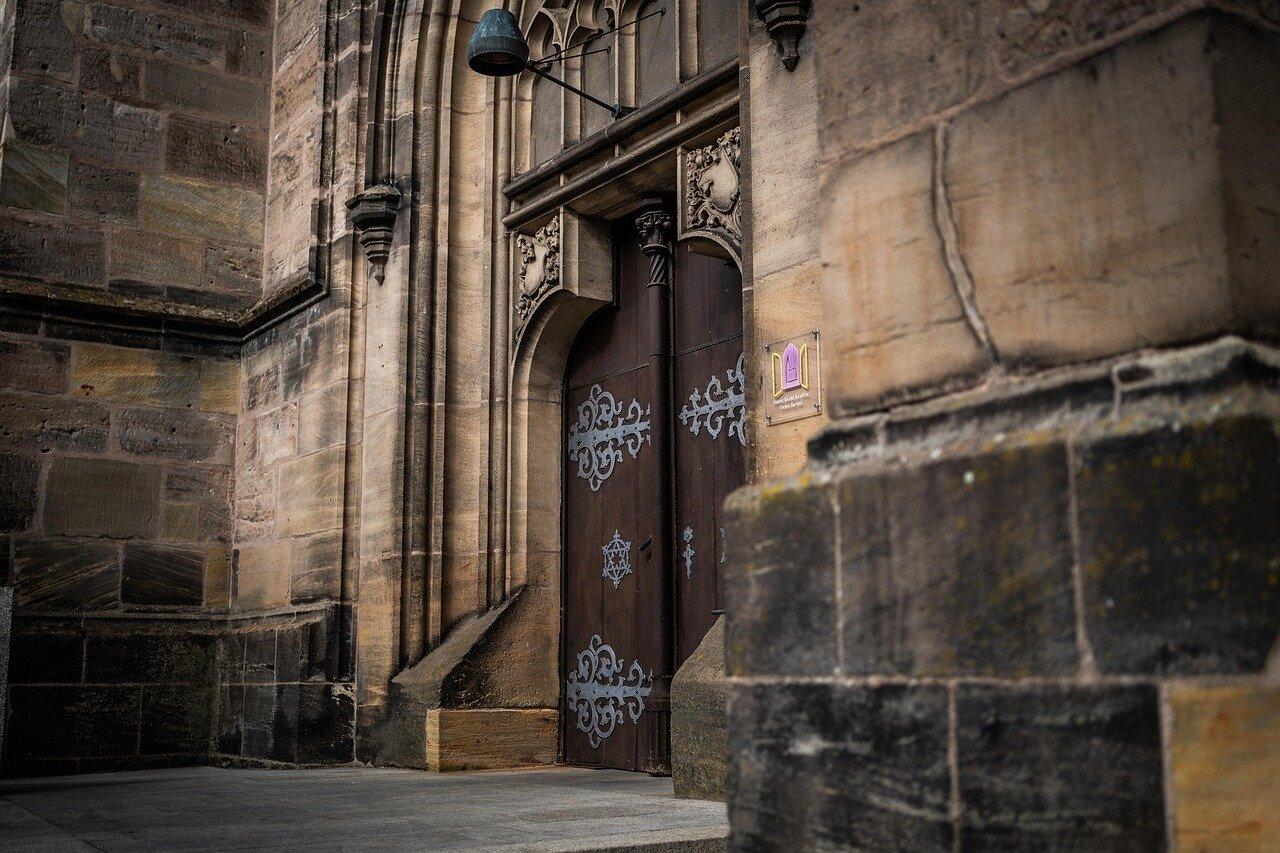 Gothic church façade and cobbled street inside Montblanc’s walled centre